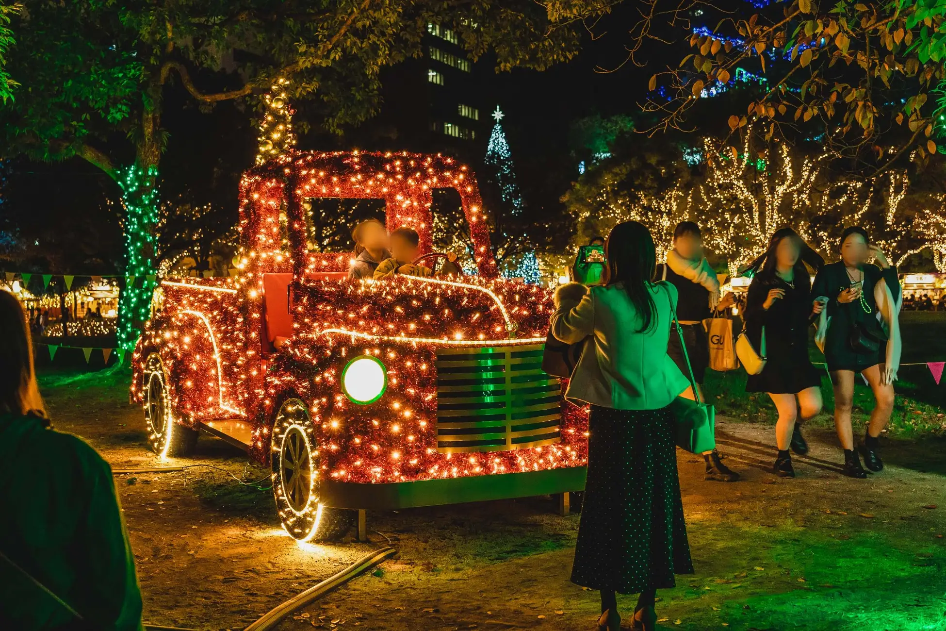 Visitors taking photos at Tenjin Central Park - Forest of Lights